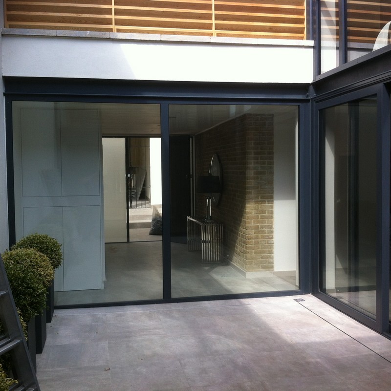 Floor-to-ceiling sliding doors opening to courtyard in Marlow