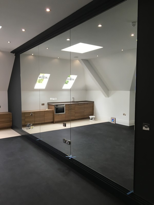 Frameless glass partition in loft conversion by Marlow glaziers
