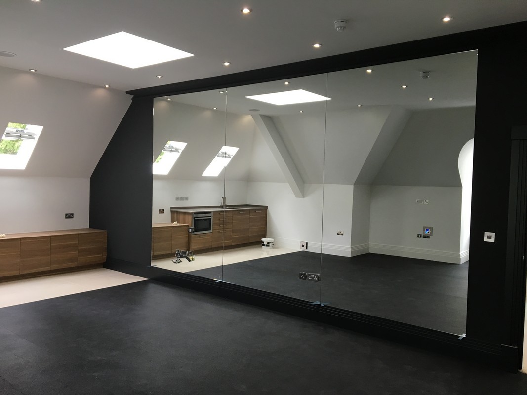 Frameless glass wall dividing loft conversion in Marlow